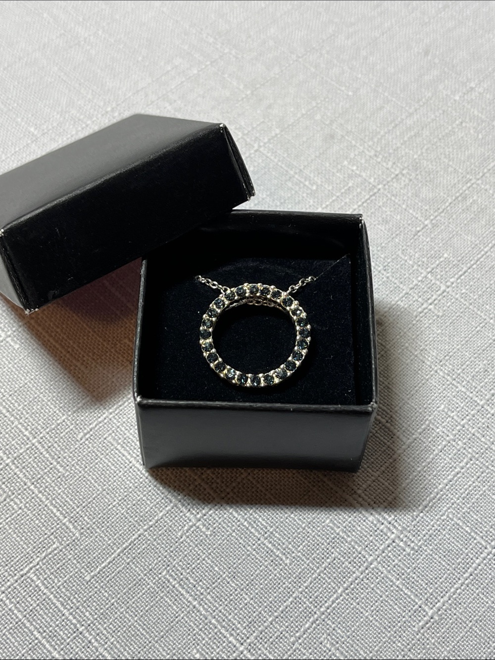 New AVON Silver Circle Pendant Necklace with dark Blue Stones
Box included